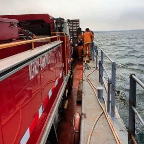 A Kernot-Grantville CFA tanker on board a barge heading to the bushfire at French Island.   