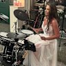 Stonnington Mayor Melina Sehr playing a drum medley at her wedding on Saturday.
