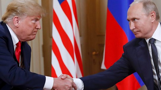 U.S. President Donald Trump, left, and Russian President Vladimir Putin shake hands at the beginning of a meeting at the Presidential Palace in Helsinki, Finland, on July 16, 2018. (AP Photo/Pablo Martinez Monsivais)