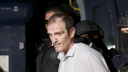 Hector “El Guero” Palma, or “Blondie,” one of the founders of the Sinaloa Cartel, is escorted in handcuffs from a helicopter at a federal hangar in Mexico City, after serving almost a decade in a US prison and transported to another maximum-security lockup to await trial for two murders. 