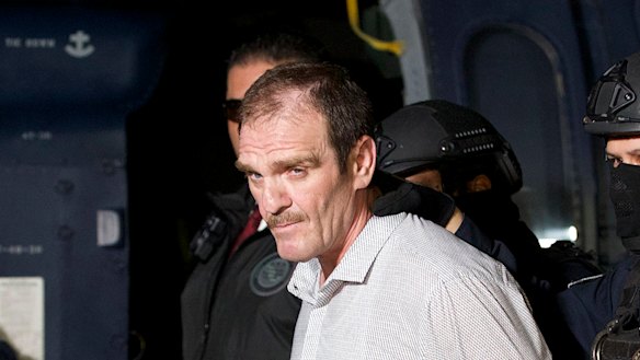 Hector “El Guero” Palma, or “Blondie,” one of the founders of the Sinaloa Cartel, is escorted in handcuffs, after serving almost a decade in a US prison. 