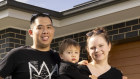 Steven and Courtney Shan with their son Lucas are packed and ready to move to their new home at Warners Bay.