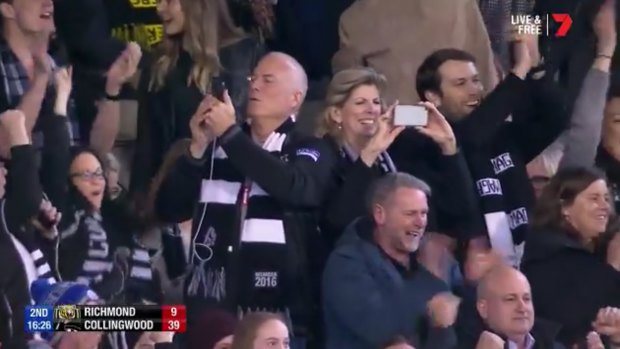 Phil and Jeanette Cox film the scenes around them after their son Mason kicks a goal. 