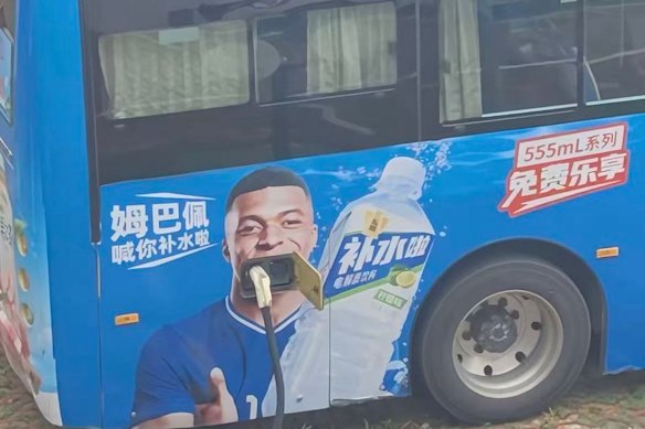 A bus in China featuring Real Madrid striker Kylian Mbappé in an advertisement for an energy drink.