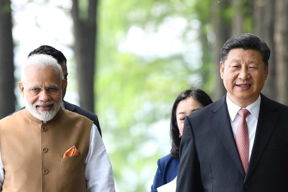 Indian Prime Minister Narendra Modi and Chinese President Xi Jinping walk together in Wuhan, central China, in 2018.