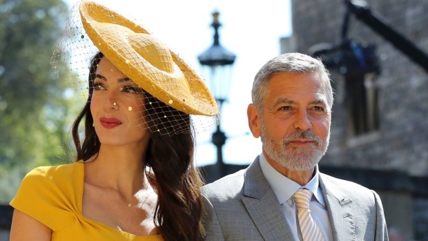 Amal Clooney and George Clooney are said to be in the running to be the two of the world's most high profile 'spiritual guides' to the latest royal baby.