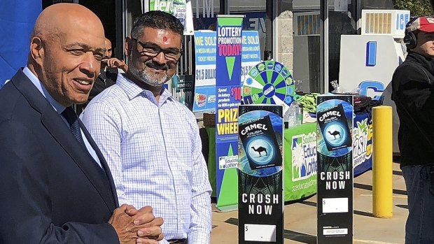 South Carolina Education Lottery chief operating officer Tony Cooper and KC Mart owner CJ Patel speak to the media after announcing the winning ticket was bought at the store.