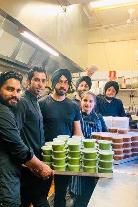 Chefs at Melbourne restaurant Horn Please with 100 serves of curry they made to donate through Alex Makes Meals to hungry health workers in Melbourne's big hospitals.