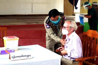 Sean Turnell is vaccinated in prison in Myanmar in this image released by the military.