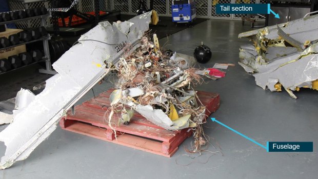 Some of the recovered pieces of VH-PAE, the Yak-52 vintage aircraft flown by Marcel van Hattem when it crashed off South Stradbroke Island,.