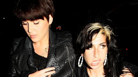 Naomi Parry and Amy Winehouse leaving the Diner Bar in Camden.