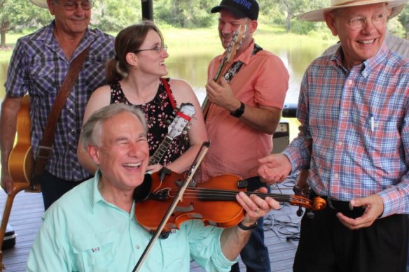 Texas Governor Greg Abbott plays the fiddle as the state’s coronavirus cases surge.