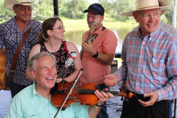 Texas Governor Greg Abbott plays the fiddle as the state’s coronavirus cases surge.