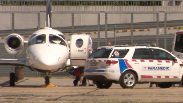 A Victorian patient diagnosed with coronavirus arrives at Essendon Airport from Darwin