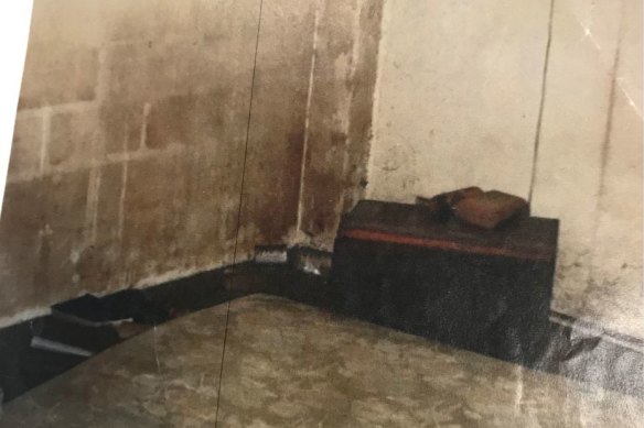 Mud-strewn walls and floors inside Judith Murphy's home in West End.