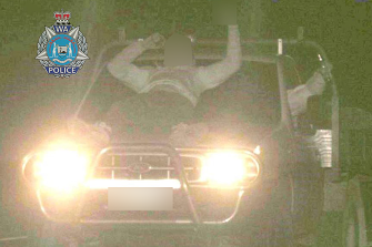 An image captured by the speed camera shows a man lying on the bonnet of the car while raising the middle finger at the camera. 