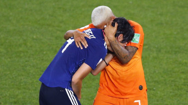 Saki Kumagai is consoled by Shanice van de Sanden after the final whistle.