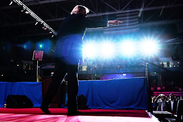 Trump on stage at the Mitchell Centre in Mobile, Alabama - another deep-red state - on Friday night.