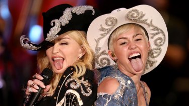 Miley Cyrus, right,  performs  the hit "We Can't Stop" with Madonna in 2014.