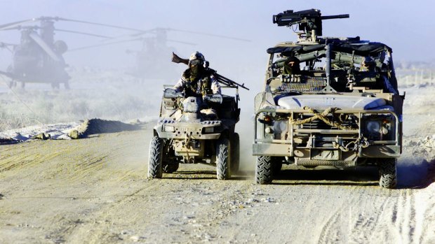 SAS soldiers on their long range patrol vehicle and a Polaris motorbike on duty in Afghanistan.