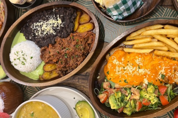 A top down photo of a restaurant table with several south american dishes