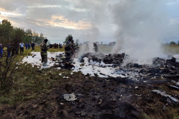 Firefighters work in the aircraft wreckage at the crash site in Russia’s Tver region.