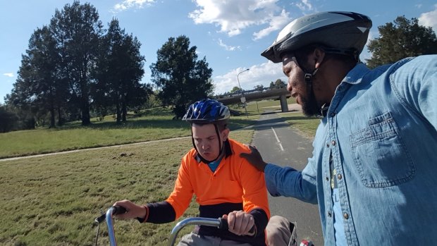 Hartley Lifecare client Cameron Smith, with his support worker  Aloysius, will ride the last kilometre of the Hartley Cycle Challenge with the leading team.