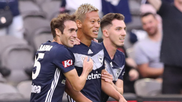 High standards: Keisuke Honda (centre) trains even on days off and wants Victory youngsters to do the same.