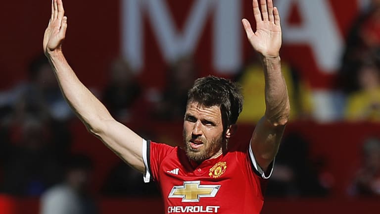 Manchester United's Michael Carrick salutes the fans as he leaves the field after his final playing appearance.