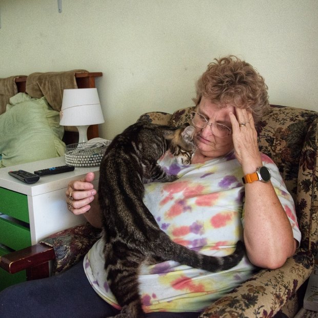 Tina Edgar, 56, places her hand on her temples during the initial phase of a cluster headache attack.