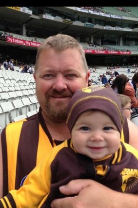 Brett Roberts with daughter at an AFL match in 2013.
