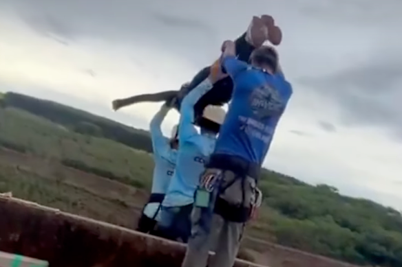 Maria Eduarda Rodrigues de Freitas, 21, being carried to the ledge for her bungee jump. 