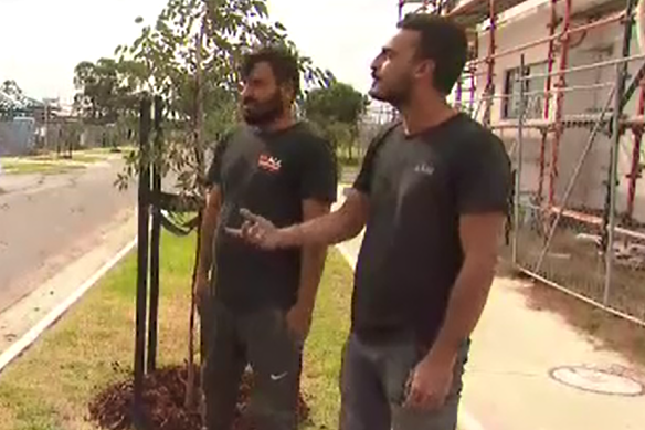 Tradesmen Reggie Racep and Huseyin Ozdemir talk to reporters after helping the driver from the car minutes before a train slammed into it.