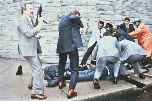 The aftermath of the assassination attempt on president Ronald Reagan in March 1981 in Washington, DC. A press secretary and security service agent are shown injured on the ground.