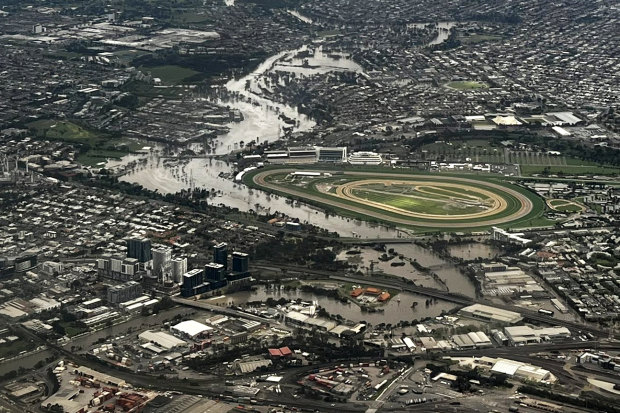 The Flemington racecourse floodwall kept the track in perfect condition on October 14. In the background is the flooded suburb of Maribyrnong.