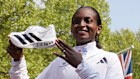Tigst Assefa of Ethiopia poses with her super shoe after setting a new women’s only world record time and winning the women’s race at the London Marathon,
