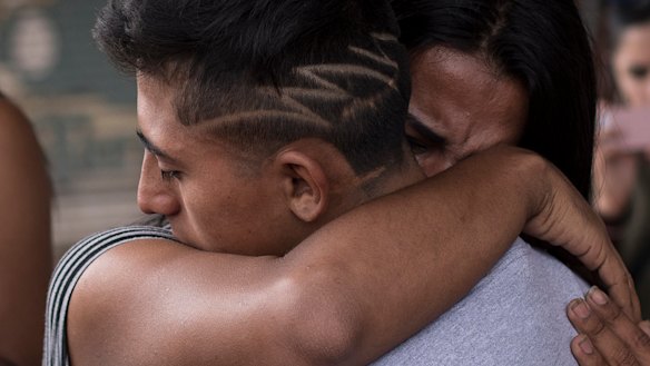 Migrants from Central America farewell each other in Tijuana, Mexico, before crossing the border and requesting asylum in the United States in May.