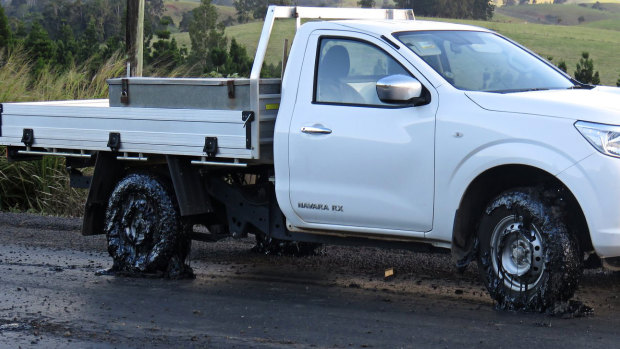 A ute's tyres are caked in tar after driving on the Millaa Millaa-Malanda Road.