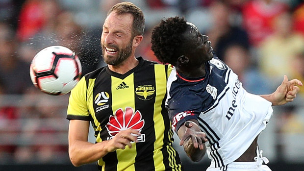 Wellington's Andrew Durante and Kenny Athiu of Melbourne Victory challenge for a ball during a recent A-League clash.