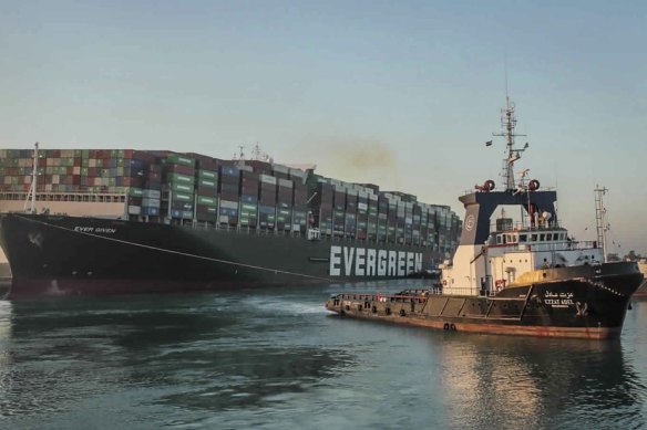 The Ever Given, a Panama-flagged cargo ship, is pulled by a tugboat in the Suez Canal on Monday.