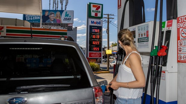 A woman fills up her car at the 7- Eleven in Rozelle, Sydney.