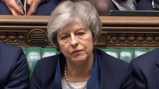 Britain's Prime Minister Theresa May listens to Labour leader Jeremy Corbyn speaking after losing a vote on her Brexit deal, in the House of Commons, London, Tuesday Jan. 15, 2019. 