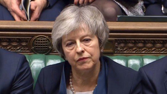 Britain's Prime Minister Theresa May listens to Labour leader Jeremy Corbyn speaking after losing a vote on her Brexit deal.