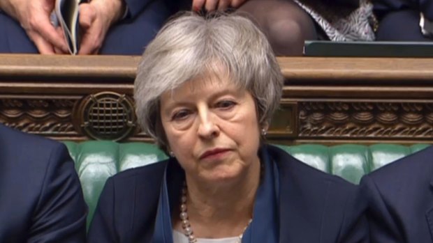 Britain's Prime Minister Theresa May listens to Labour leader Jeremy Corbyn speaking after losing a vote on her Brexit deal.