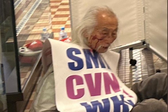 Sydney protester Danny Lim on the floor of the QVB after police discontinued their arrest of him on Tuesday morning.