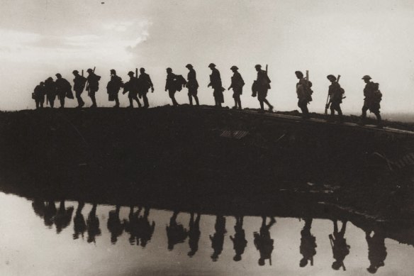 Supporting troops of the 1st Australian Division walking on a duckboard track near Hooge, in the Ypres Sector, in October 1917.