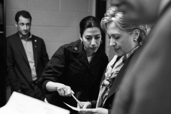 Abedin and Clinton on the 2008 presidential campaign trail, with Weiner in the background. 