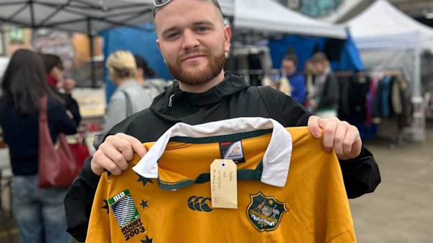 Nick Christie proudly holding a vintage 2003 Wallabies World Cup jersey in Melbourne
