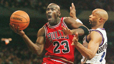 Michael Jordan takes flight against Toronto's Alvin Robertson in 1996.