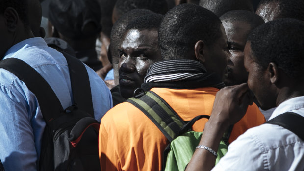 Migrants are detained by French police after being evacuated from the Panthenon in Paris.